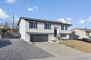 Split foyer home featuring a garage