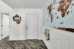 Entrance foyer with dark hardwood / wood-style flooring