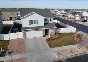 View of front property with a garage and a front lawn