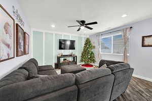 Living room featuring ceiling fan and wood-type flooring