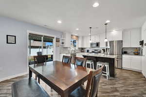 Dining area featuring a textured ceiling, sink, and dark hardwood / wood-style floors