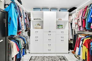 Spacious closet with light tile patterned flooring