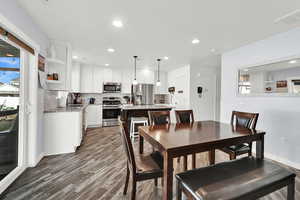 Dining space with wood-type flooring and sink