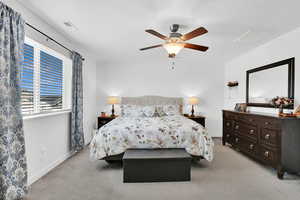 Carpeted bedroom with ceiling fan