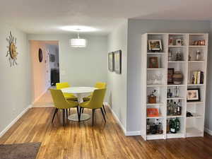 Dining room featuring a textured ceiling and hardwood / wood-style flooring