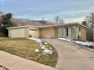 Single story home featuring a mountain view and a garage