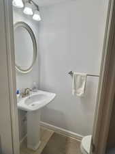 Bathroom featuring tile patterned flooring and toilet