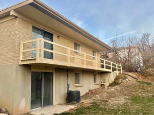 View of side of property with a balcony and central air condition unit