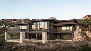 Rear view of property featuring a patio and a balcony