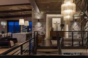 Interior space with vaulted ceiling with beams, a mountain view, wooden ceiling, and hardwood / wood-style flooring