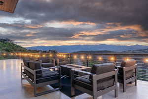 Patio terrace at dusk with a mountain view and an outdoor fire pit