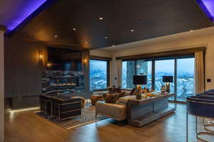 Living room featuring wood-type flooring and a high end fireplace