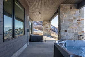 View of patio / terrace with a hot tub