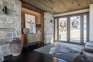 Foyer with dark hardwood / wood-style flooring and wood ceiling