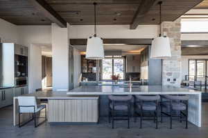 Kitchen featuring oven, wood ceiling, and a wealth of natural light