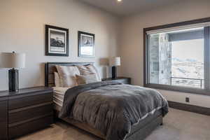 Bedroom featuring light colored carpet