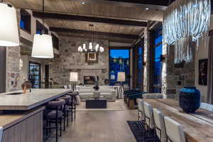 Kitchen featuring sink, pendant lighting, wooden ceiling, beamed ceiling, and light hardwood / wood-style floors