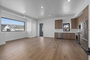 Kitchen with a wealth of natural light, and high end appliances with stainless steel finishes