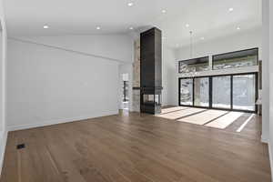 Living room with a multi sided fireplace, and high vaulted ceiling