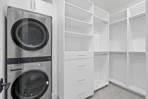 ADU closet Featuring Stackable washer dryer and soft close cabinets.