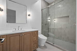 Bathroom with tile patterned flooring, vanity, a shower with shower door, and bidet toilet