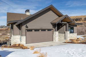 View of front of house featuring central AC and a garage