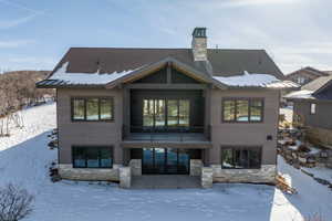 View of snow covered back of property