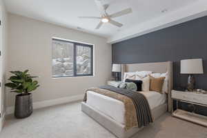 Carpeted bedroom featuring ceiling fan