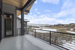 Snow covered back of property featuring a mountain view