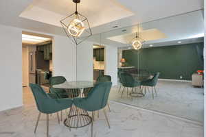 Dining room with a raised ceiling