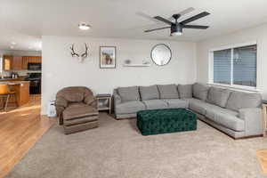 Living room featuring ceiling fan and light hardwood / wood-style floors