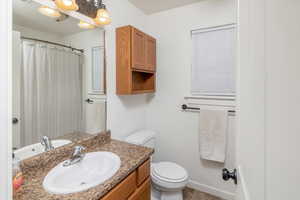 Bathroom with tile patterned floors, vanity, and toilet