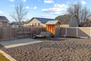 Rear view of property with a patio and a storage unit