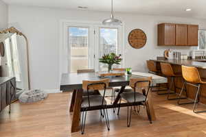 Dining room featuring sink and light hardwood / wood-style floors