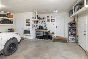 Garage featuring a workshop area and heating unit