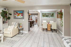 Dining area with ceiling fan, light wood-type flooring, and french doors