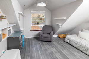 Bedroom featuring dark hardwood / wood-style floors, ceiling fan, and lofted ceiling