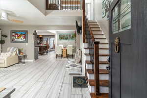 Entrance foyer with ceiling fan, hardwood / wood-style floors, and a textured ceiling