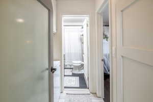 Hallway featuring light tile patterned floors