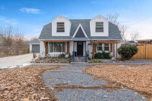 Cape cod home featuring a garage