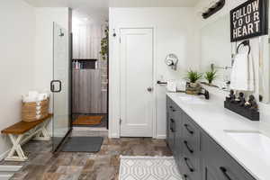 Bathroom featuring vanity and an enclosed shower