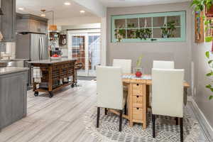 Dining space featuring sink and light hardwood / wood-style floors