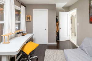 Office area featuring dark wood-type flooring