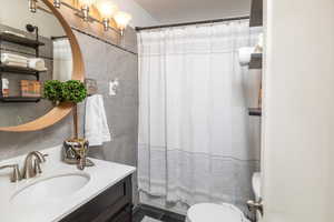 Bathroom featuring tile patterned flooring, vanity, and toilet