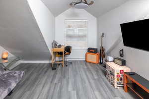 Office space featuring hardwood / wood-style floors and lofted ceiling