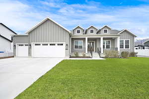 View of front facade with a lovely landscaped yard, porch, 3-car garage plus RV Parking space