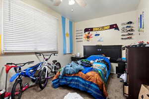 Carpeted bedroom with ceiling fan