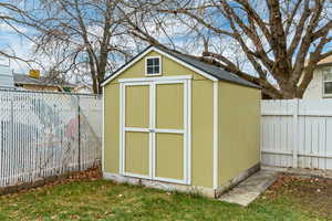 View of outbuilding with a yard