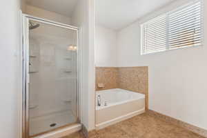 Bathroom with separate shower and tub and tile patterned floors