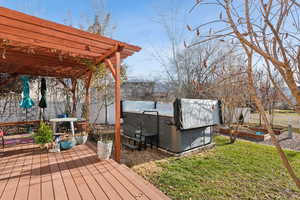 Wooden deck with a pergola and a hot tub-swim spa